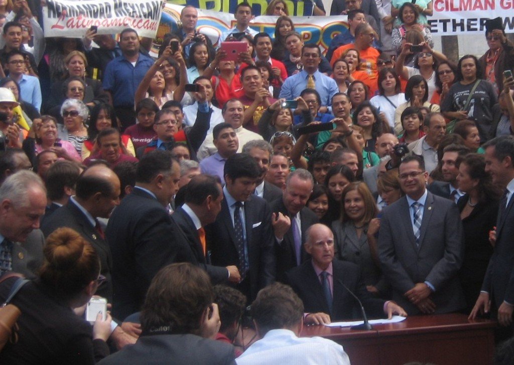 Governor Jerry Brown as he signs AB60 into law on October 3, 2013.